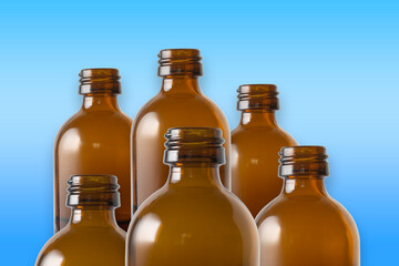 Brown glass bottles on a row. The rustic and vintage jars are clean. They look like old medicin keepings. Standing with light blue gradient background