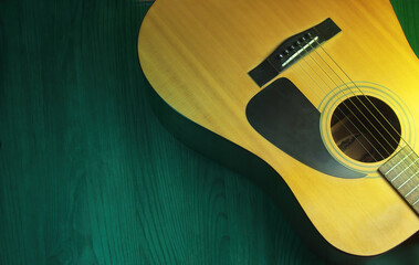 An acoustic guitar, in a music concept template. Close up shot to the body of the guitar with copy...
