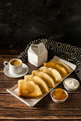 Breakfast. Russian pancakes with sour cream and jam. A cup of espresso.