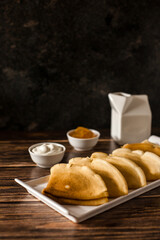 Breakfast. Russian pancakes with sour cream and jam. A cup of espresso.