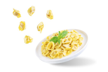 Fresh prepared Tortellini pasta with basil on a white isolated background