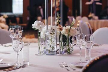 tableware Glasses, flower fork, knife served for dinner in restaurant with cozy interior