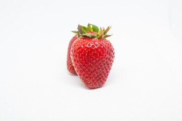 Two strawberries on the white backround