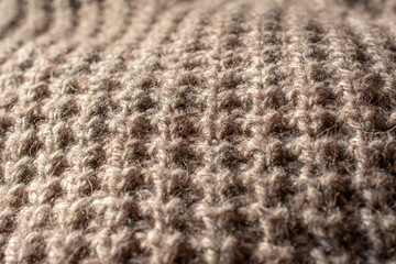 Close up of a large knitted jumper. English knit. Natural colours. Vertical view.