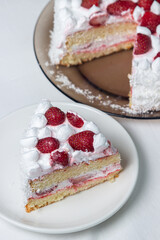 Creamy strawberry cake. Homemade cake with whipped cream and fresh strawberries. Cut piece of cake