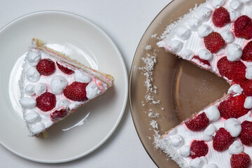 Creamy strawberry cake. Homemade cake with whipped cream and fresh strawberries. Cut piece of cake