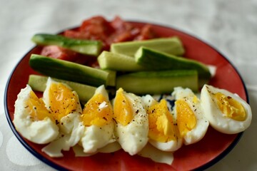 Slices of a boiled egg and salad for breakfast
