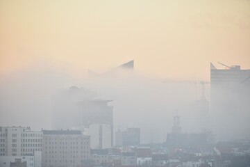 City centre and buildings are covered by morning mist