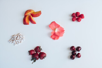 cherry, peach, raspberry, strawberry on white background