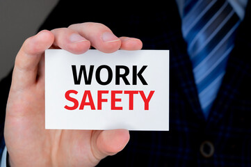 Work Safety. Man holding a card with a message text written on it