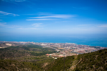 Fototapeta na wymiar Benalmádena teleferico shot from the top of Calamorro with city and coastline in the background. Andalusia, Spain.