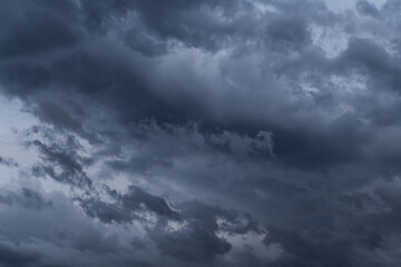Epic dramatic storm sky with dark grey black cumulus rainy clouds in the wind, background, texture, thunderstorm