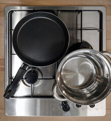 new inbuilt gas- stove with pans, above