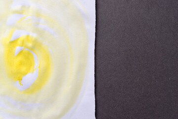 bright cadmium yellow watercolour background in the shape of a large swirl on white sketchbook paper