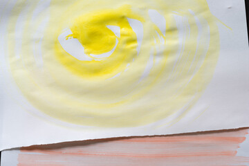 bright cadmium yellow watercolour background in the shape of a large swirl on white sketchbook paper
