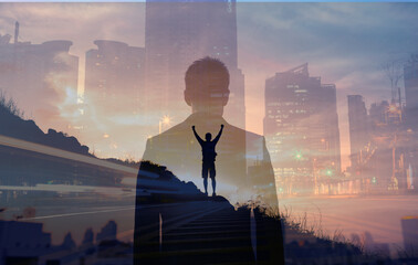 Fototapeta Young confident business man facing the city view. Man celebrating on a mountain top. People vision and inner strength, never giving up concept.  obraz