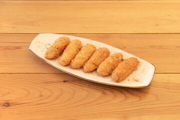 delicious Spanish tapa of homemade croquettes breaded and stuffed with cream with Iberian ham