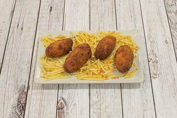 Homemade Iberian ham croquettes with straw potatoes
