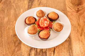 delicatessen croquettes of jerky and Iberian ham accompanied by a tomato flower served as chocolates