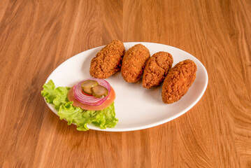Proportion of creamy jerky croquettes for tapas restaurant with a salad appetizer