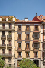 Fototapeta na wymiar Facades of characteristic houses in the center of Madrid on a sunny spring day