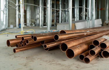 A pile of valuable copper pipe at a condominium construction site in Canada - obrazy, fototapety, plakaty