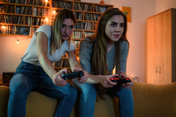 Two best friends playing video games while relaxing at home