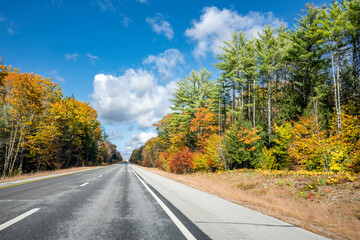 Landscape with a skyline abutting highway with picturesque autumn maple trees in New Hampshire New England