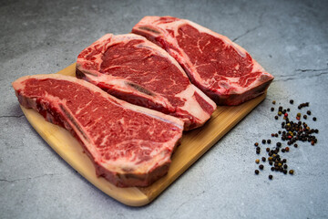 Raw pieces of fresh beef on a cutting board.