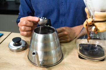 Preparing coffee with glass chemex in the coffee shop. The Chemex coffee machine is a device to