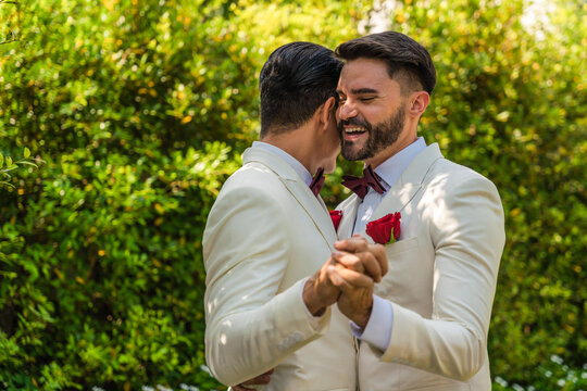 LGBTQ gay couple happy dancing together in wedding ceremony