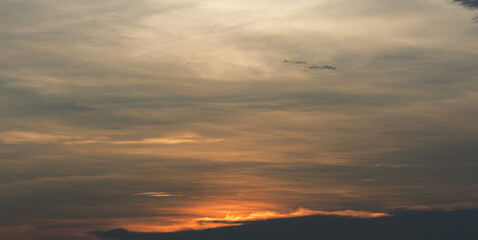 Beautiful sunset sky above clouds with dramatic light