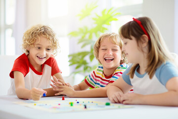 Family playing board game. Kids play.