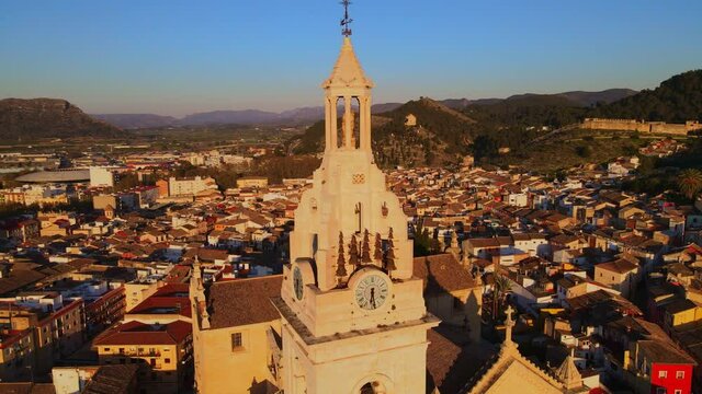 The beautiful church of X&aacute;tiva with its tower, clock and bell tower from an aerial view.