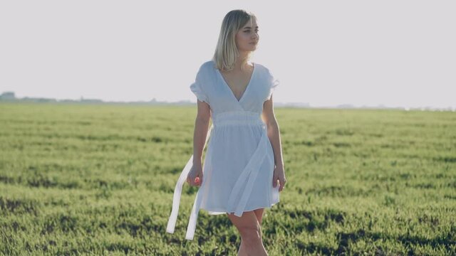 blonde girl walking in the field