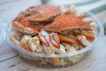 Steamed horse crab claws in circle box on wooden board background