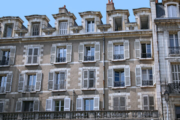 Old fashioned European working class apartment building with shutters that can be closed to keep out light and noise