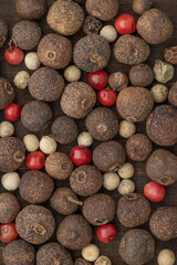 Dry peas of allspice and hot peppers of different colors and sizes. Background and wallpaper, close-up.