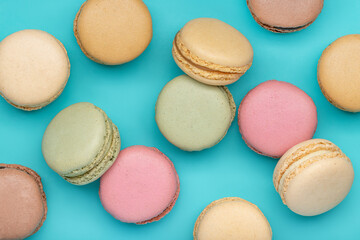 Fototapeta na wymiar Macaroons, different colors on a dark blue background. Top view, close-up.