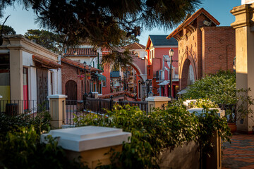 Open view of elegant outdoor Spanish architecture shopping mall on bright sunny day