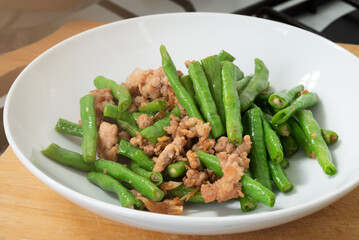 Close up stir-fried cowpeas or black-eyed beans with minced pork with garlic and soy sauce, food in...