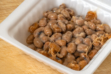 Close up Natto or Fermented Soy in foam package, melting from frozen.