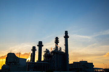Fototapeta na wymiar Oil refinery plant chemical factory and power plant with many storage tanks and pipelines at sunset.