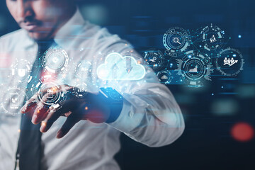 ฺBusinessman uses smartwatch to open cloud computing network interface to work on business technology. The concept of developing innovative nanotechnology business.