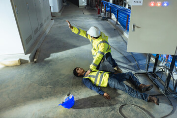 Supervisor first aid help injured worker accident electric shock unconscious. Asian electrician worker accident electric shock unconscious in site work. - obrazy, fototapety, plakaty