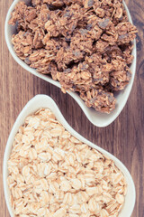 Oat flakes and granola with chocolate in bowl, healthy food for breakfast concept