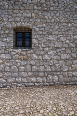 Fototapeta na wymiar White Stone Castle Wall with Small Window