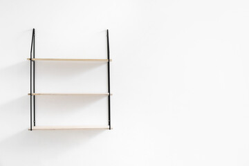 Modern shelf hanging on white wall