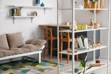 Interior of modern kitchen with shelf unit