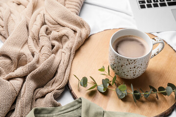 Composition with cup of coffee on bed